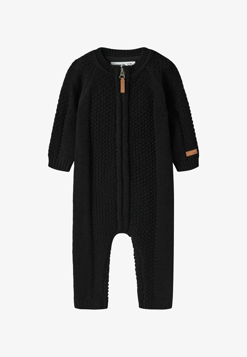Combinaison tricotée noire pour bébé avec manches longues et fermeture éclair devant, avec des motifs texturés et une petite languette de fermeture éclair marron.