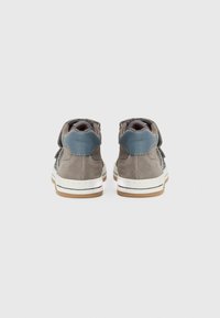 Grå semsket høyhælte sneakers med en blå lærh�æl, hvit gummisåle og borrelåsdetalj på siden.