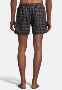Men's swim shorts in dark gray with a geometric pattern. Elastic waistband with drawstring, side pocket, and soft, lightweight fabric.