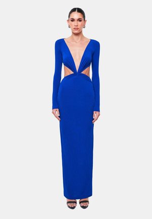 Vestito lungo blu realizzato in tessuto a coste, con scollatura a V profonda, maniche lunghe, dettagli cut-out in vita e una silhouette aderente.