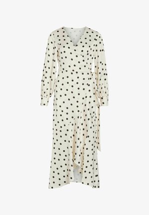 Robe portefeuille crème à pois noirs, manches longues bouffantes, encolure en V, ceinture à la taille et ourlet asymétrique à volants.