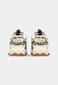 Black and beige leopard-print athletic shoes with a white midsole, rubber outsole, and a black loop on the heel. Gold FILA logo at the back.