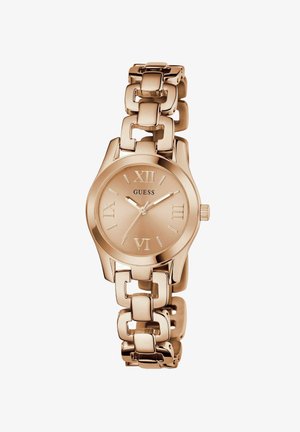 Ružićasti zlatni sat s okruglim licem i rimskim brojevima. Ima metalnu narukvicu i teksturiranu završnu obrtnu na brojčaniku.