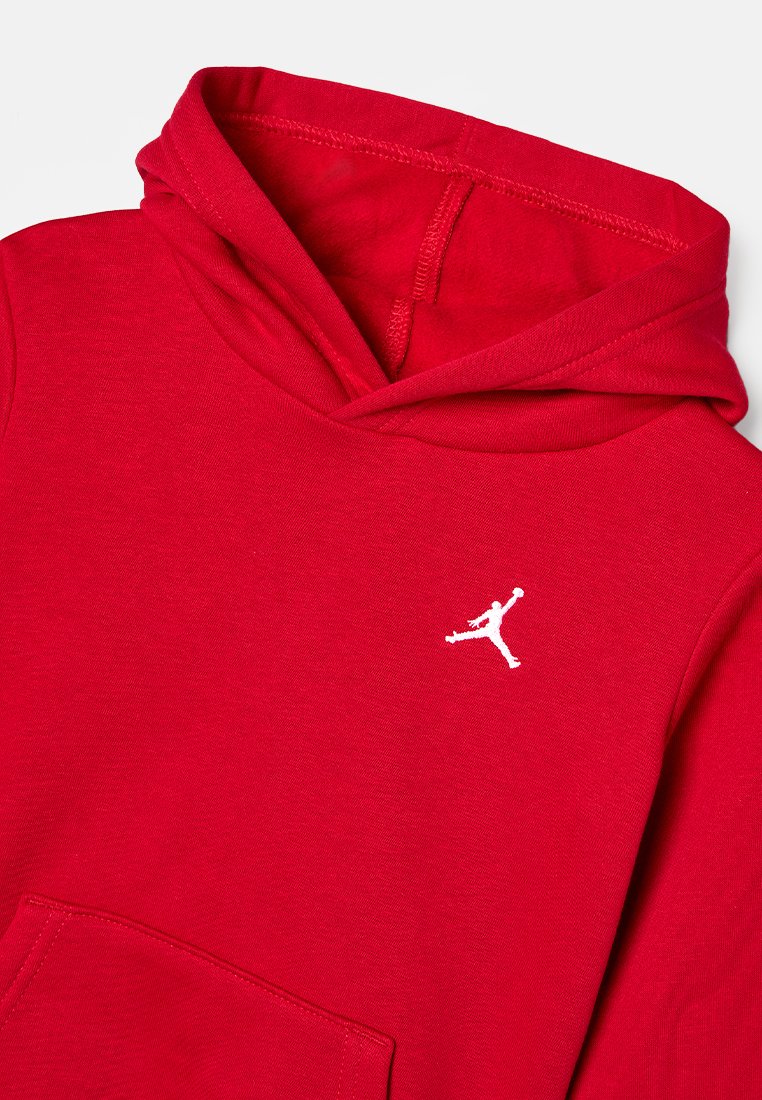 Roter Kapuzenpullover aus Baumwollmaterial, mit Fronttasche und einem weißen Jumpman-Logo. Glatte Textur mit verstärkten Nähten.