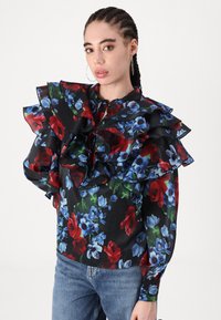 Floral blouse featuring ruffled sleeves, predominantly black with red and blue flower patterns, made of lightweight fabric. Casual fit design.