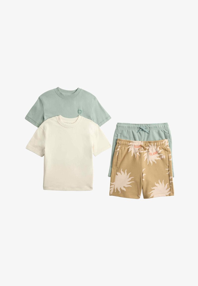 Deux t-shirts unis à manches courtes en vert sauge et crème, associés à un short vert sauge et un short beige avec des imprimés de soleil blancs et le texte « Island Life ».