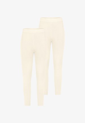 Cremfarbene, gerippte Leggings mit figurbetontem Design und elastischem Bund, zeichnen sich durch eine glatte Textur und nahtlose Verarbeitung aus.