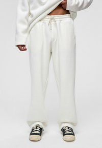 Witte sweatpants van zachte stof, met een elastische tailleband en een trekkoord, twee zijzakken en een losse pasvorm.