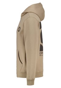 Beige hoodie with a front kangaroo pocket, logo graphic in black, long sleeves, and ribbed cuffs. Hood features drawstring for adjustment.