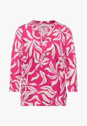 Langärmlige rosa Bluse mit abstrakten weißen, orangefarbenen und braunen Blattmustern und rundem Ausschnitt mit Kordelzügen.