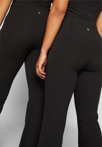 Athleta ELATION FLARE PANT - Leggings - black