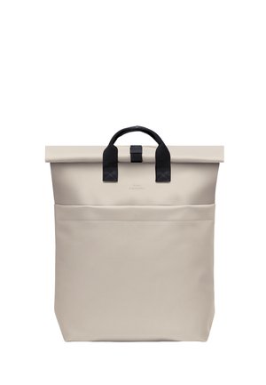 Beige roll-top backpack with black handles and front pocket, made of smooth, water-resistant material.