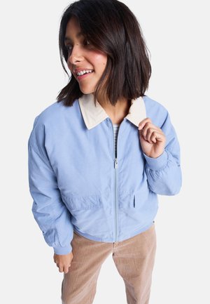 Light blue bomber jacket with a beige collar, featuring a zip front, two side pockets, and ribbed cuffs. Smooth fabric with a relaxed fit.