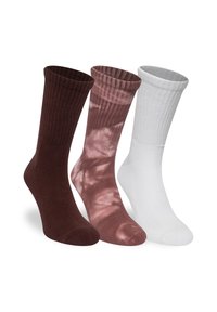 Set med tre strumpor: enfärgad mörkbrun, tie-dye i rosa och enfärgad vit. Blandning av bomull, ribbad textur, crew-längd, designade för vardagligt bruk.