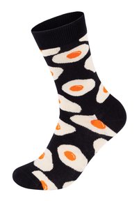 Czarne skarpetki z powtarzającym się wzorem białych smażonych jajek z pomarańczowymi żółtkami, wykonane z miękkiego, elastycznego materiału.