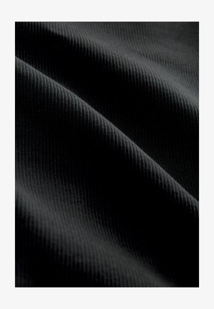 Schwarzer gerippter Stoff mit leicht glänzender Textur, der feine vertikale Linien und eine glatte Oberfläche aufweist und Elastizität demonstriert.