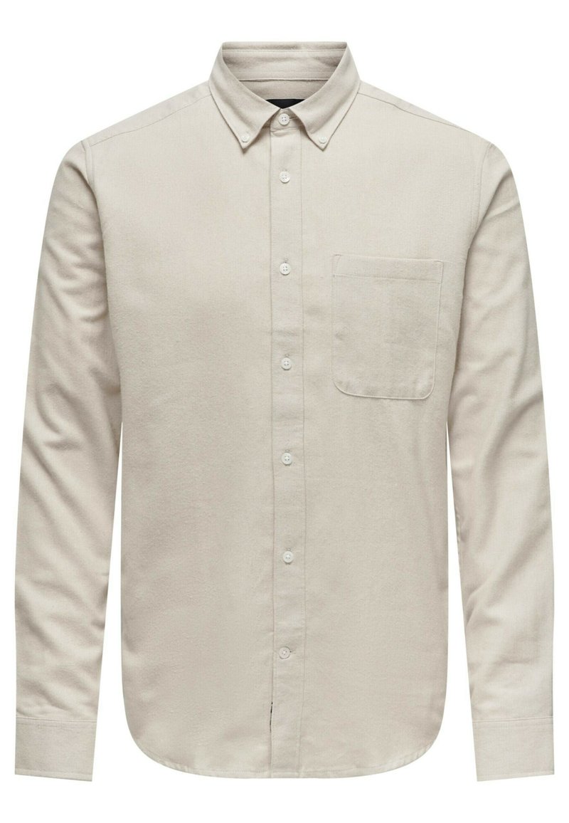 Camisa de manga larga abotonada en beige claro, hecha de una tela texturizada. Presenta un pequeño bolsillo en el pecho y un diseño de cuello clásico.