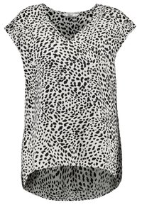 Blusa a maniche corte bianca e nera a pois con scollatura a V e orlo asimmetrico.