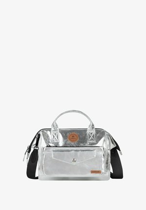Silver metallic bag with dual handles, adjustable strap, front pocket, leather accent patch, and geometric stitching details.