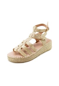 Gold glittered strappy sandal with an adjustable ankle strap, espadrille jute platform sole, and a smooth light tan footbed.