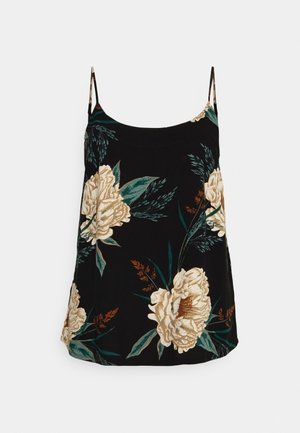 Camisole noire à fleurs avec fines bretelles, présentant de grandes pivoines crème et des feuilles vertes sur un fond en tissu texturé.
