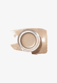 Beigecreme in einem klaren, runden Behälter, umgeben von einem helleren beige Farbton. Glatte Textur mit schimmerndem Finish.