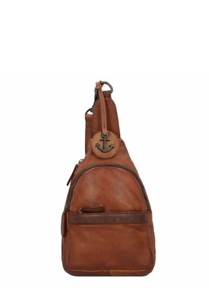 Brown leather sling bag with a rounded shape, featuring a front pocket, zipper closure, and anchor detail on the shoulder strap.