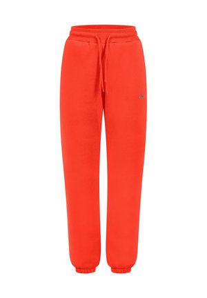 Pantalones de chándal rojos hechos de tela suave, con una cintura elástica con cordón, piernas ajustadas y puños en los tobillos.