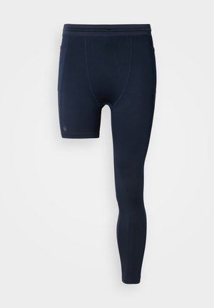 Navyblå atletiske shorts med tætsiddende design, elastisk taljebånd og sidelommer, lavet af et glat, elastisk stof.