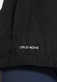 Black jacket featuring a smooth texture with "CEPLEX ACTIVE" label in white. The design displays a streamlined silhouette.