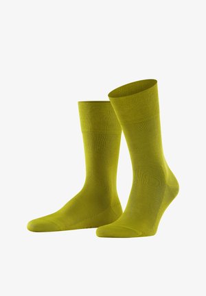 Grüne Baumwollsocken mit gerippter Textur, in mittlerer Höhe bis zur Wade, mit verstärkten Zehen- und Fersenbereichen, in einfarbig ohne Muster.