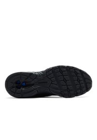 Black athletic shoe sole with a textured rubber surface, featuring raised patterns for traction, and a visible brand logo in the center.