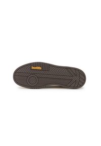 Suela de zapato de goma marrón con patrón de zigzag, con un detalle circular y el logo "koolik". Textura suave y forma redondeada.