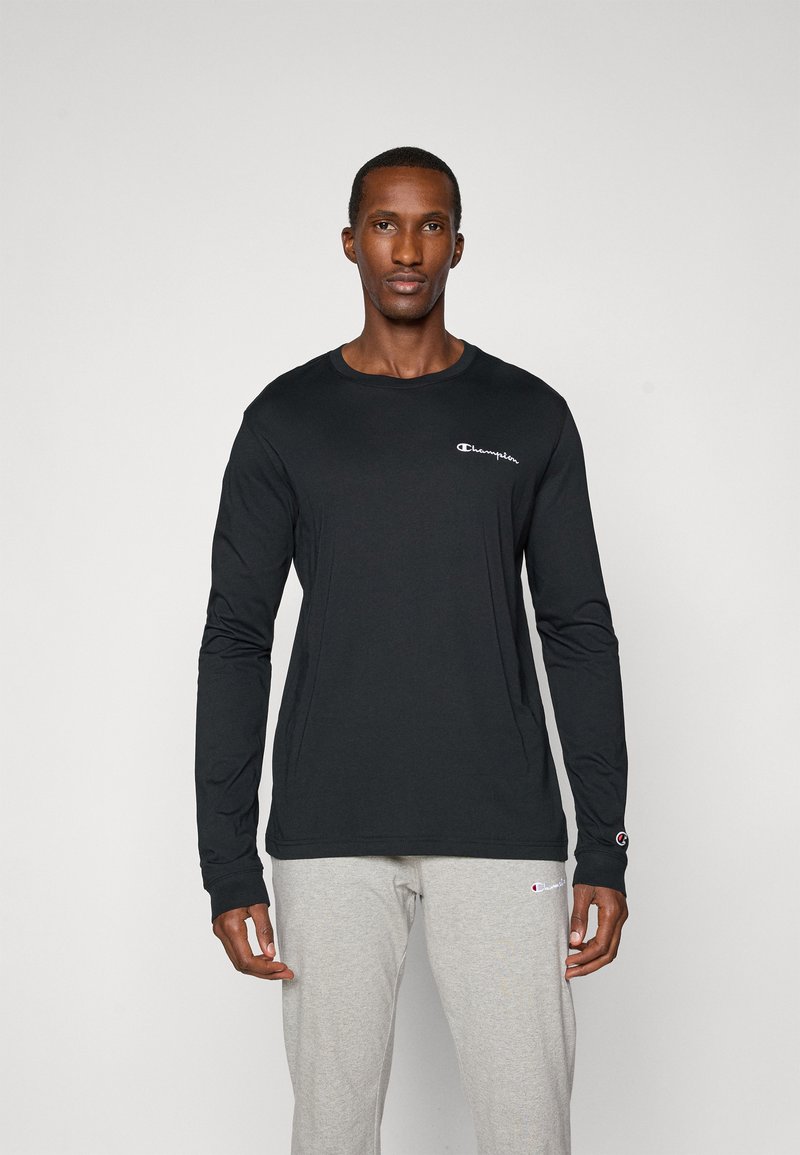 Black long-sleeve t-shirt made of soft fabric, featuring a crew neck, fitted design, and a small white logo on the left chest.