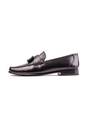 Black leather men's loafer with tassels, stitched detailing, and low stacked heel, shown in profile on white background.