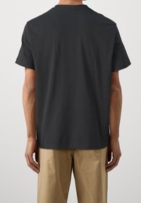 Black cotton short-sleeve t-shirt with a crew neckline and straight hem. Features a plain back design, minimal detailing.