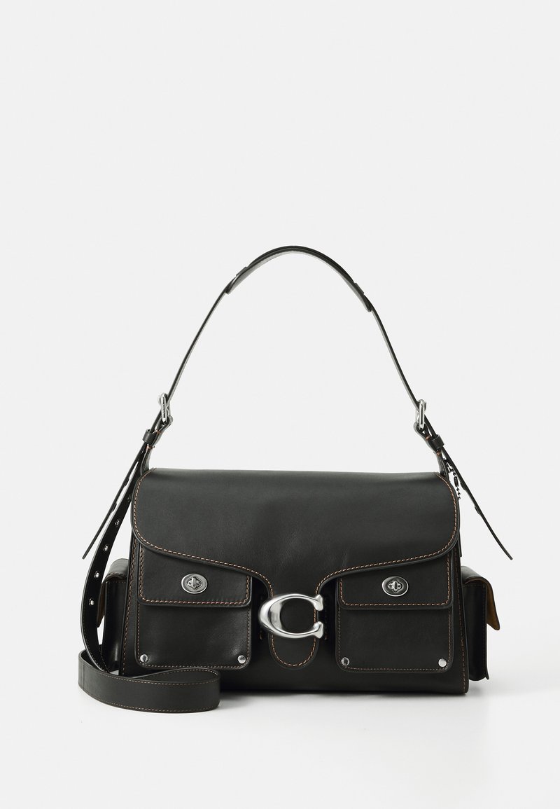 Black leather handbag with a flap closure, silver hardware, two front pockets, contrasting stitching, and a detachable shoulder strap.