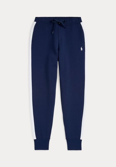 Navy blue sweatpants with white side stripes, elastic waistband with drawstring, cuffed ankles, and small logo on front. Soft fabric texture.