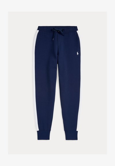 Navy blue sweatpants with white side stripes, elastic waistband with drawstring, cuffed ankles, and small logo on front. Soft fabric texture.