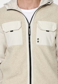 Koroshi Jachetă din fleece - beige