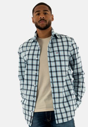 Camicia a maniche lunghe con bottoni, in un motivo a quadri blu e neri. Realizzata in cotone, presenta un colletto classico, maniche lunghe e un piccolo logo.