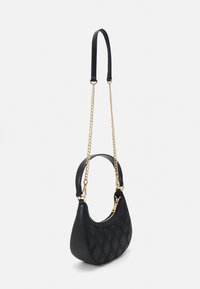 Black quilted handbag featuring a curved silhouette, a smooth leather body, and a gold chain strap with a leather top handle.