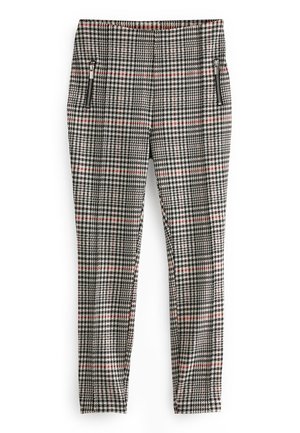 Pantalon slim à motif pied-de-poule noir, blanc et rouge, avec deux poches avant zippées sur fond blanc.