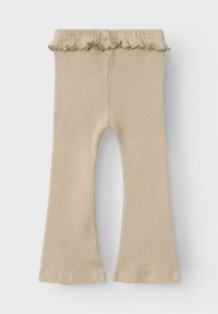 Leggings beige a coste con orlo svasato e vita arricciata. Realizzati in un tessuto morbido, progettati per comfort e flessibilità.