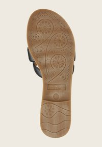 Semelle de sandale en caoutchouc brun avec des motifs floraux et des textures en vagues, comportant un logo de marque et un indicateur de taille. La forme est plate et profilée.