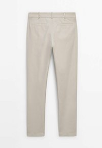 Ljust beige skräddarsydda byxor med en slät yta, två bakfickor och bälteshällor. Designen har en rak benform.