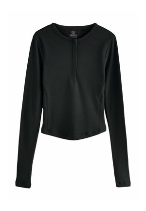 Čierny dlhý rukáv top vyrobený z ribbovaného materiálu s henley výstrihom, ktorý obsahuje gombíkovú légou a skrátený strih.