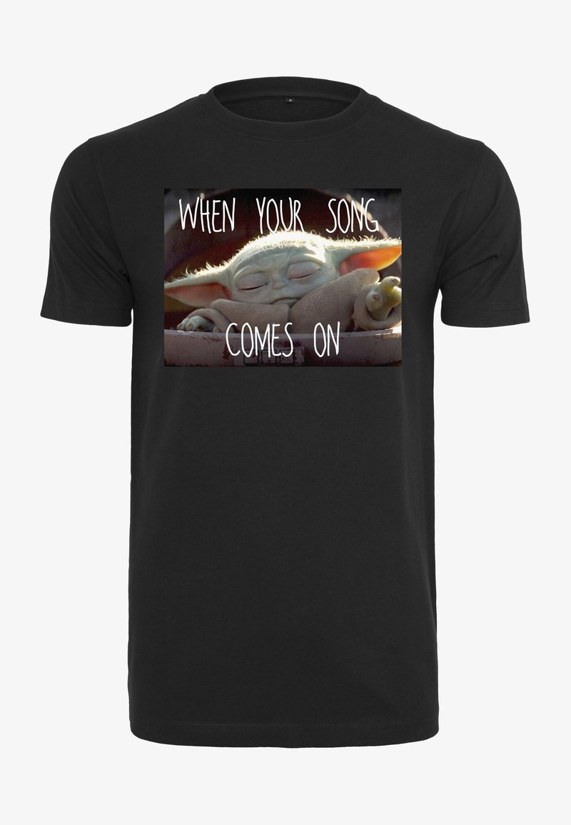 Black cotton t-shirt featuring a printed graphic of a sleeping character with the text "WHEN YOUR SONG COMES ON." Short sleeves and crew neck.