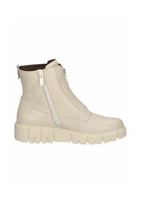 Bottine en cuir couleur crème avec des zips latéraux doubles, semelle blanche épaisse et finition texturée. Elle présente un bout arrondi et un intérieur doux.