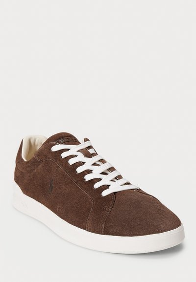 Brown suede sneaker with white laces and sole, featuring a subtle embroidered logo on the side.
